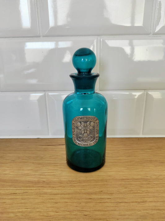 RARE Ancien flacon en verre bleu et étain Jeux olympiques d'hiver 1968. En direct des pistes de ski.... Ancien flacon/garniture de toilette en verre d'un joli bleu et étiquette en étain Jeux olympiques d'hiver Grenoble 1968. En déco, il saura faire son effet en accumulation avec d’autres formats ou d'autres couleurs. En parfait état, aucun éclat ni même sur le bouchon.