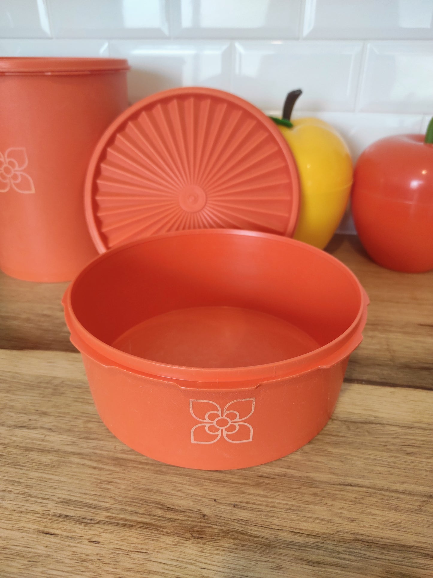 Boite TUPPERWARE soleil orange vintage. Boite TUPPERWARE soleil orange des années 80. Avec son couvercle en forme de soleil, vous n'aurez qu'à appuyer au milieu pour la fermer. En très bon état, made in France.