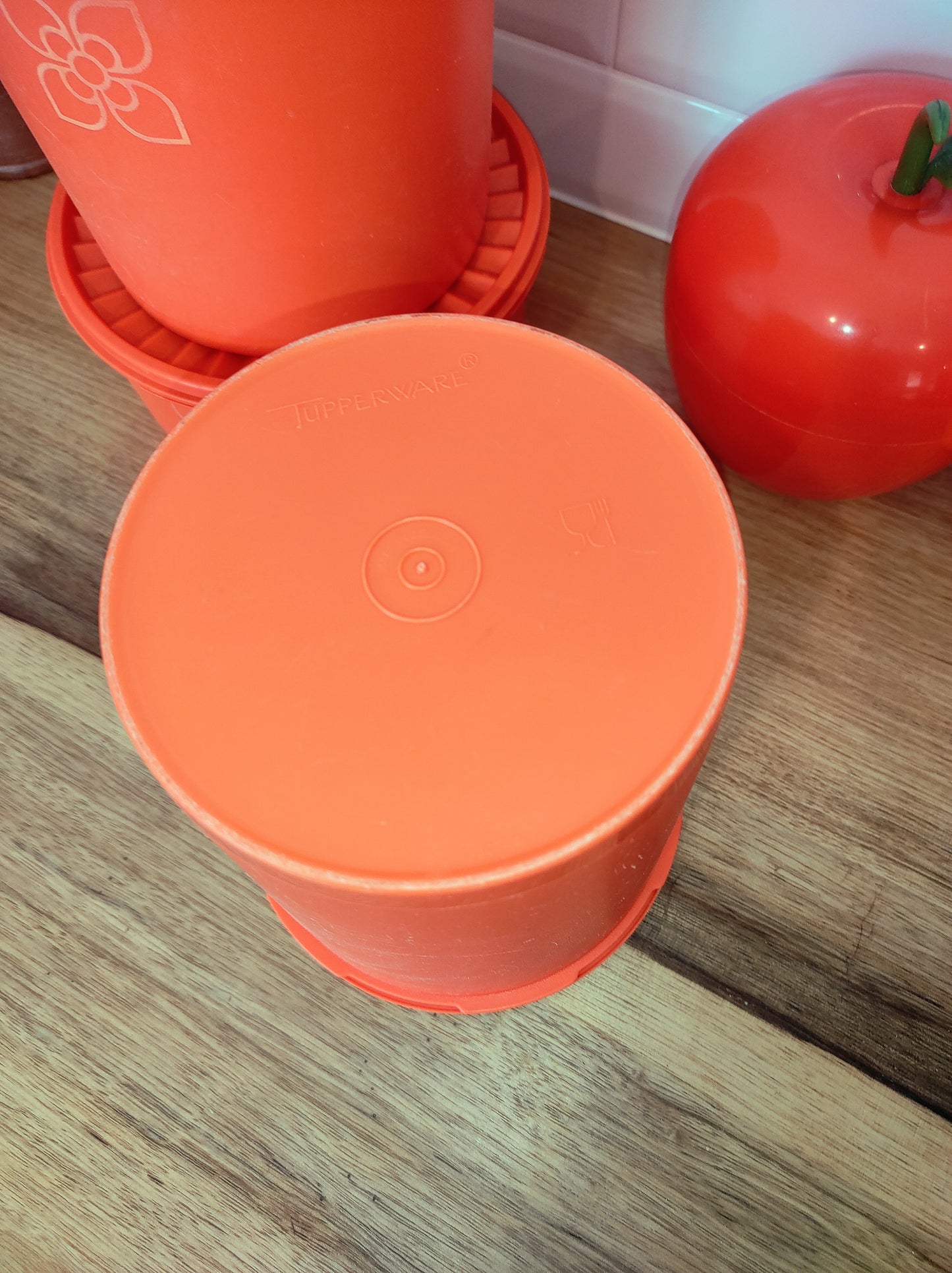 Boite TUPPERWARE soleil orange vintage. Boite TUPPERWARE soleil orange des années 80. Avec son couvercle plissé comme un soleil, vous n'aurez qu'à appuyer au milieu pour la fermer. En très bon état, made in France.