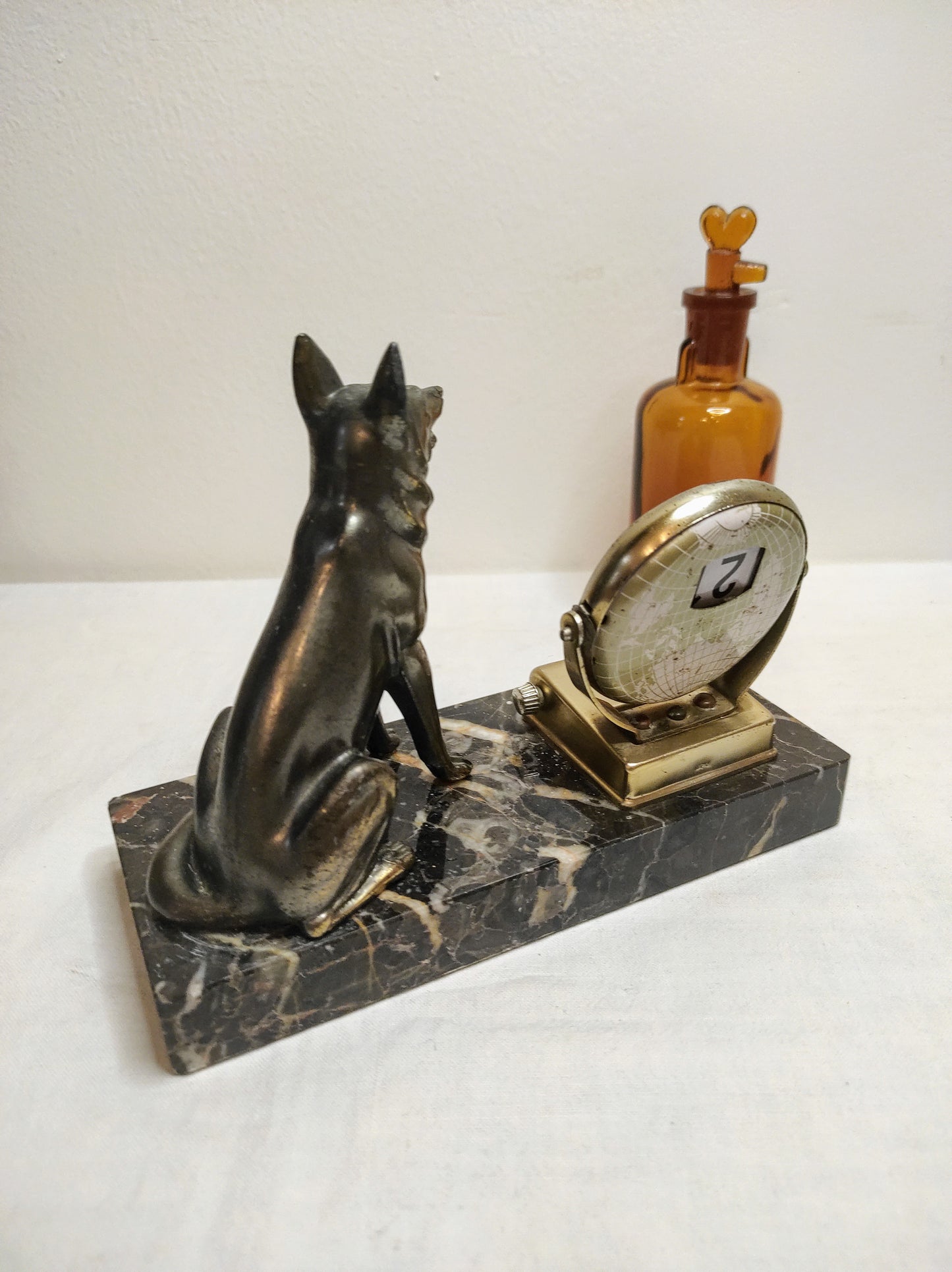 Ancien calendrier perpétuel en marbre et régule. Attention Rex monte la garde et surveille la date du jour ! Avec cet ancien calendrier perpétuel en régule monté sur un marbre gris foncé et blanc qui donnera un air vintage à votre bureau vous ne changerais plus de calendrier tous les ans ! Malgré des traces du temps il est en très bon état. Calendrier vintage