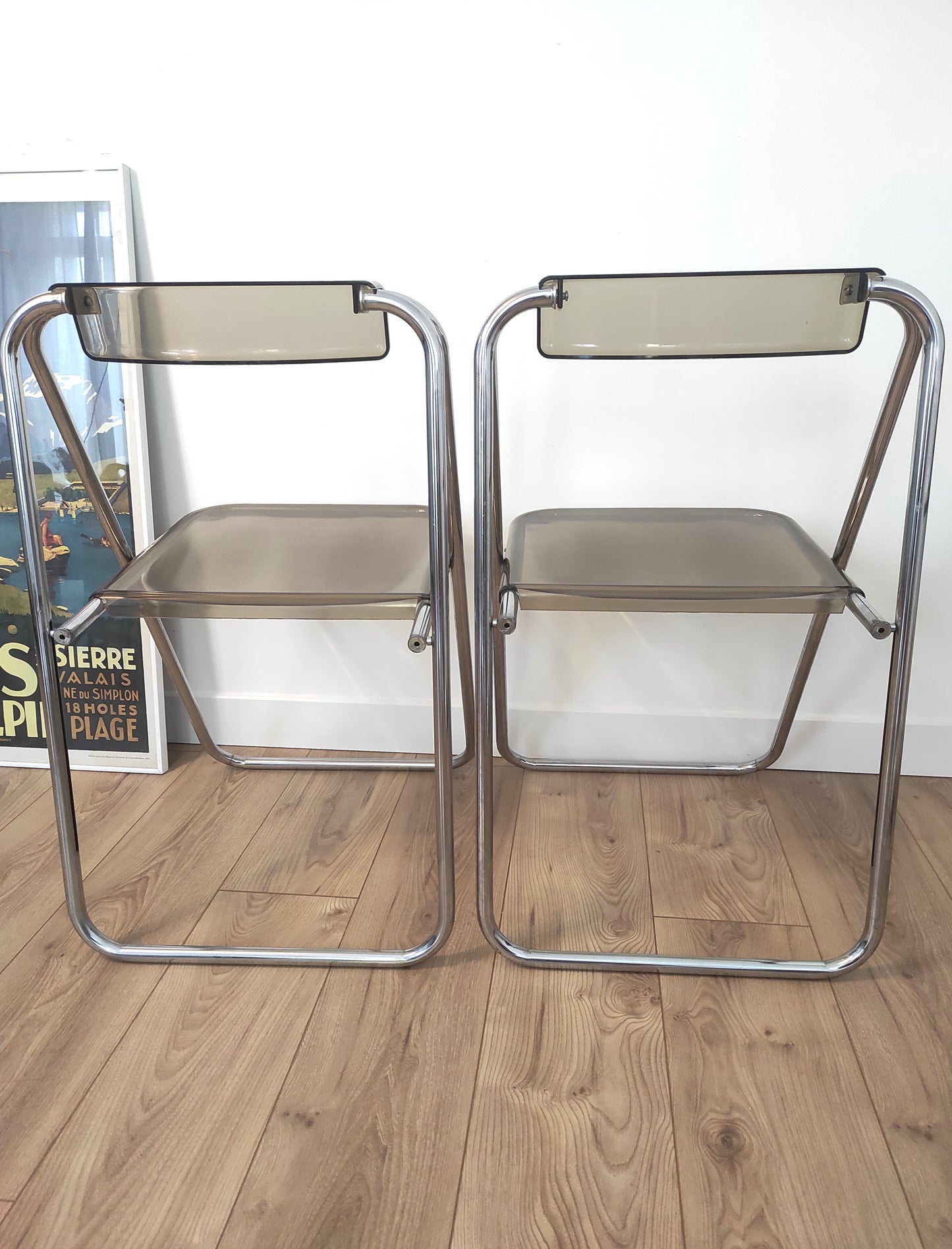 Paire de chaises pliantes vintage plexiglas fumé par Aldo Jacober style PLIA. On aime la simplicité et look très seventies de cette jolie paire de chaises du designer ALDO JACOBER dans le style PLIA GIANCARLO PIRETTI CASTELLI. Elles sont totalement dans leur jus depuis les années 70. En plexiglas fumé et métal chromé, peu encombrantes, elles seront parfaites dans votre bureau ou autour de votre table ! Les chaises, pour leur âge sont en très bon état malgré quelques traces du temps.