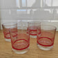 Set de 4 verres à eau vintage by Covetro. Ensemble de 4 verres à eau par Covetro, made in Italy des années 80.  La couleur rouge des liserés est encore bien présente excepté sur un des verres où elle est légèrement passée. 